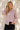 Chemise rose à pois femme portée avec un pantalon noir